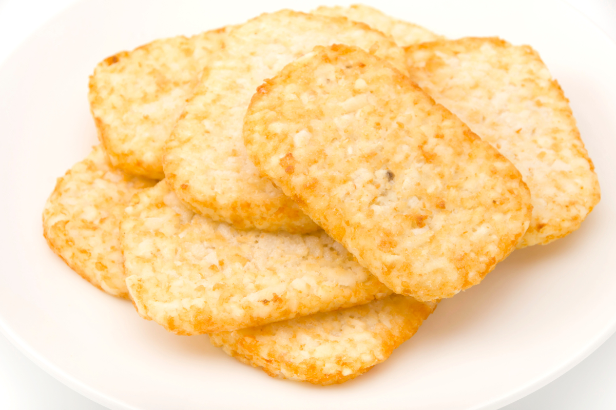 Shredded potato hash browns in a frozen state.
